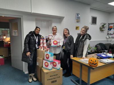 A group of people stood behind stacked donation boxes