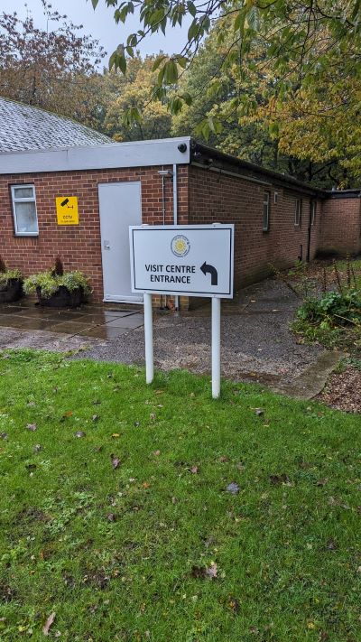 A sign in front of a brick building